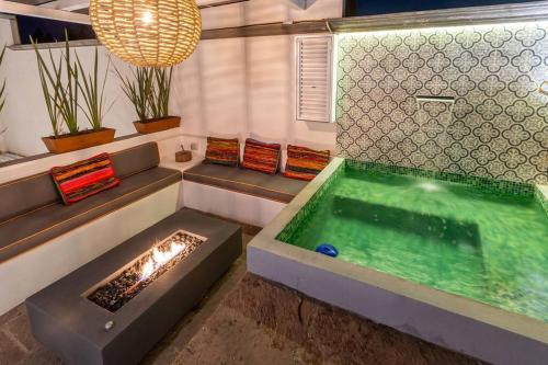 a bathroom with a hot tub and a fireplace at Casa Nico - a boutique home in Centro San Miguel in San Miguel de Allende