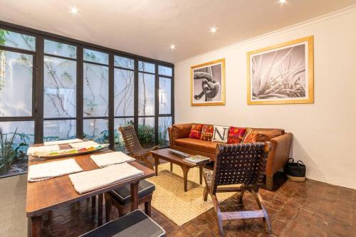 a living room with a couch and a table at Casa Nico - a boutique home in Centro San Miguel in San Miguel de Allende