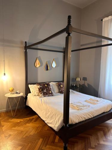a bedroom with a black canopy bed in a room at Botta 9 in Bergamo