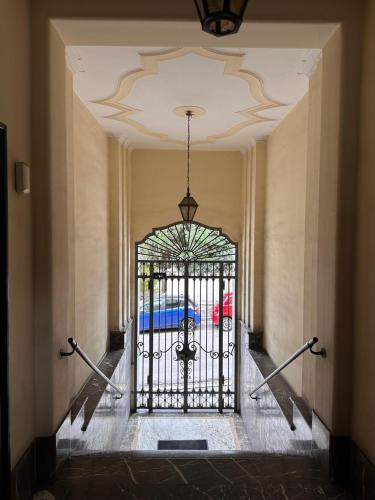 a gate in a hallway with a car behind it at Botta 9 in Bergamo