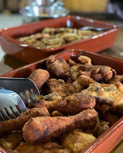 a tray of food with a fork and a dish of food at Hotel Fazenda Rancho Mineiro in Engenheiro Paulo de Frontin