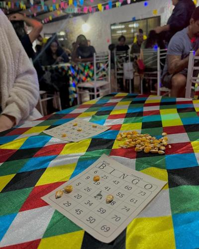 a table with a multicolored table cloth with beads on it at Hotel Fazenda Rancho Mineiro in Engenheiro Paulo de Frontin
