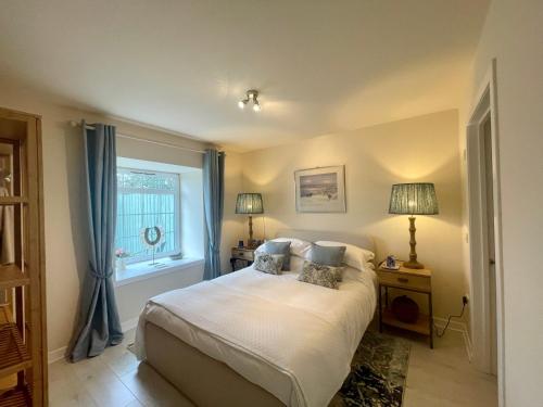 a bedroom with a bed and a window at No 2 Ramageton in Troon