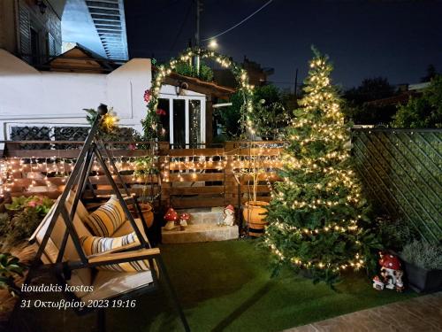 a christmas tree in the yard of a house at Zoe garden home in Spáta