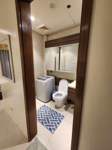 a bathroom with a toilet and a sink at Tambuli maribago residence in Lapu Lapu City