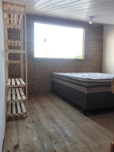 a bedroom with a bed and a window and a ladder at Casa Descanso dos Amigos in Prado