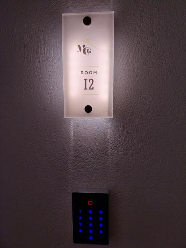a lightswitch on a wall with a clock on it at Marousos Central Guesthouse in Portariá