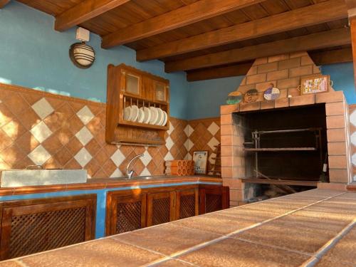 a kitchen with a stove and a stone oven at Mirador Azul in El Paso