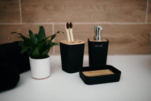 a counter with two utensils and a black container with chopsticks at VIP apartments Bitola in Bitola