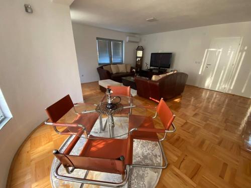 a living room with a glass table and chairs at Luxury apartment in Bitola