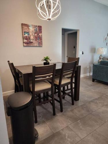 a dining table and chairs in a living room at Home Away from Home with Heated Pool in New Port Richey