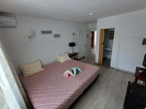 a bedroom with a bed with a pink bedspread at Guest House Casa Ramos on the Strip in Albufeira