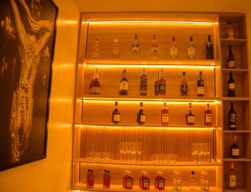 a display of bottles and glasses in a room at Elcastillo Homes in Lagos