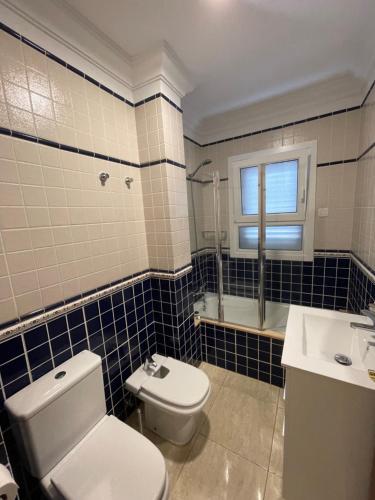 a bathroom with a toilet and a sink at Villa Costa in Santa Cruz de Tenerife