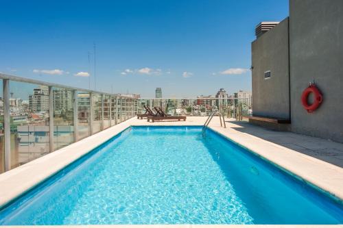 a swimming pool on the roof of a building at High End Cozy Apt at CENTRAL RECOLETA -Amazing View- 12H in Buenos Aires