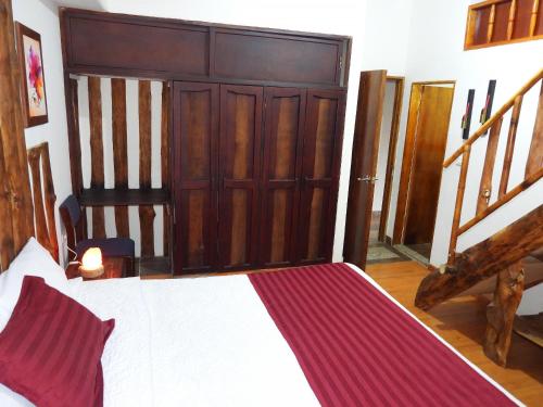 a bedroom with a bed and a wooden door at La Molienda Casa Hotel in San Agustín