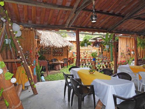 a restaurant with tables and chairs in a room at La Molienda Casa Hotel in San Agustín