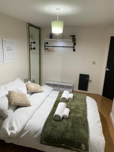 a large white bed with three towels on it at Luxury 1 or 2 bedroom Apartment Birmingham City Centre in Birmingham