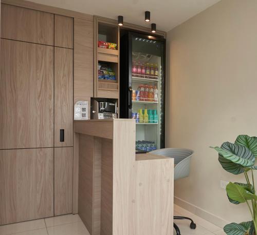 a drink station in a room with a refrigerator at Elemont Hotel in Medellín