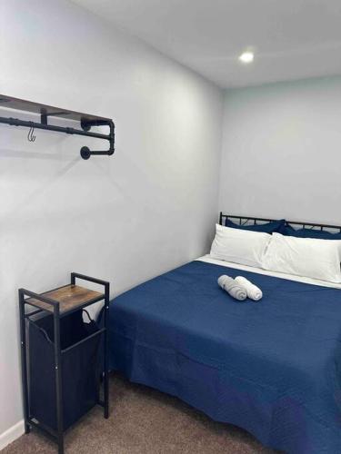 a bedroom with a blue bed with two towels on it at Two bedrooms with parking & washer/dryer in Schenectady