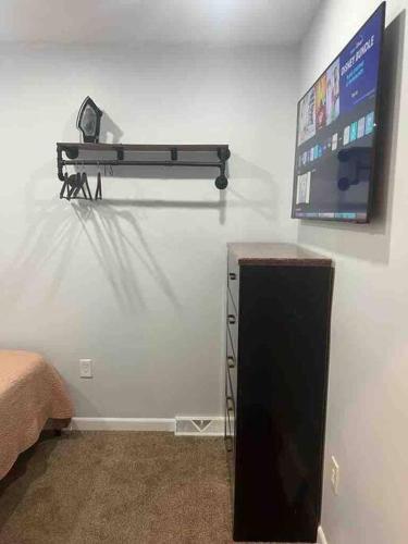 a room with a flat screen tv on a wall at Two bedrooms with parking & washer/dryer in Schenectady