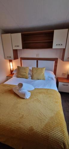 a bedroom with a large bed with a bowl on it at Bill's Retreat - Lodge & Hot tub in Morpeth