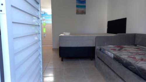 a bedroom with a bed and a bed frame at Pousada Lagoinha in Ubatuba