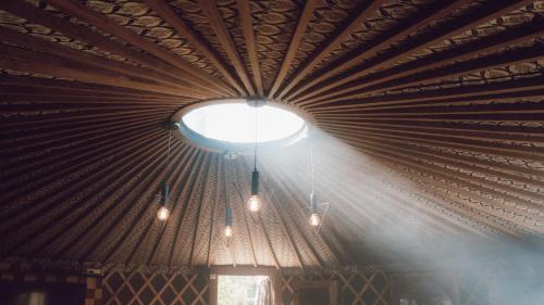 a ceiling with a large light in a room at Glamping montain experience in São Joaquim