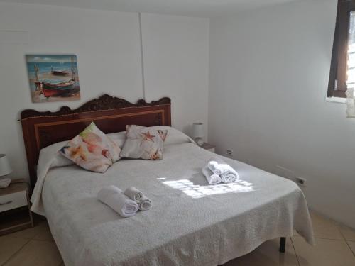 a bed with towels and slippers on top of it at Via Pasquale Testa in Formia