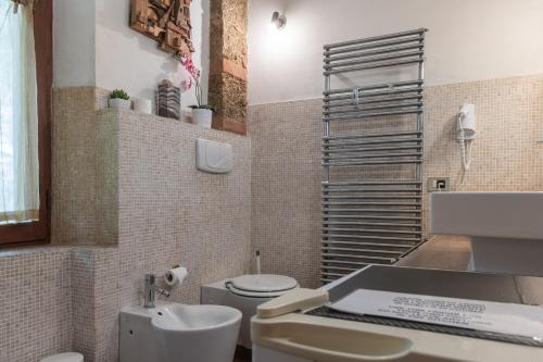 a bathroom with a toilet and a sink and a sink at Antico Podere Il Bugnolo in Poggibonsi