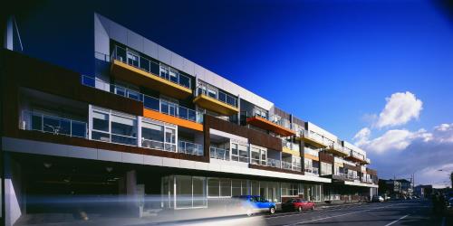a tall building with cars parked in front of it at St Kilda Central Apartments in Melbourne