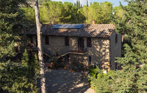 an aerial view of a house with solar panels on the roof at Antico Podere Il Bugnolo in Poggibonsi
