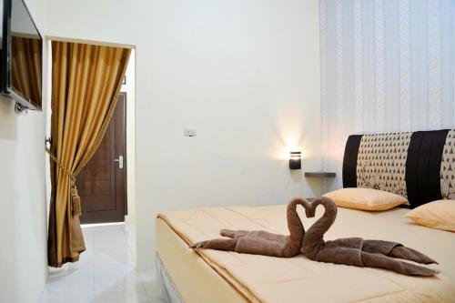 Postel nebo postele na pokoji v ubytování Haura syariah home stay