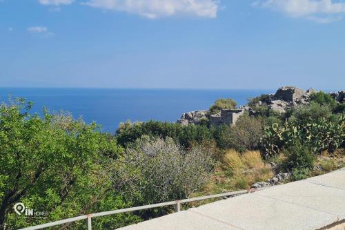 a view of the ocean from a road at Mani Tu With Breathtaking View 2 in Éxo Nímfion