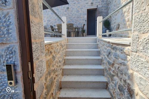 a set of stairs leading to a door at Mani Tu With Breathtaking View 2 in Éxo Nímfion