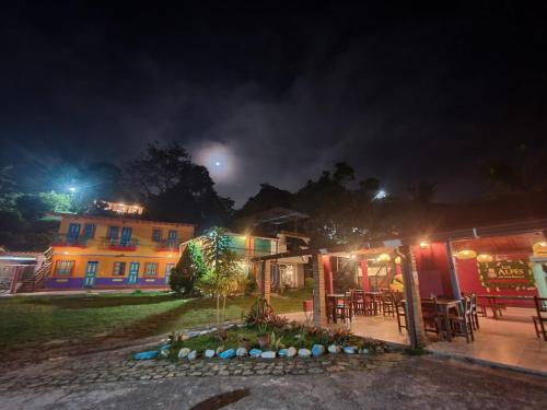 a night view of a building and a restaurant at Hosteria Los Alpes de San Roque in San Roque