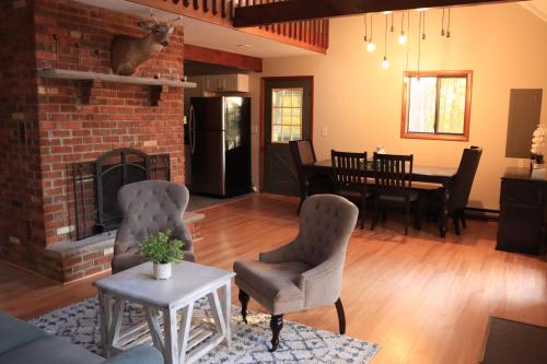 a living room with two chairs and a fireplace at Rosie’s Cabin in Thornhurst