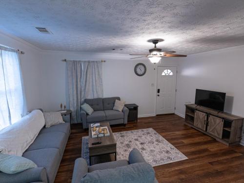 a living room with a couch and a tv at Columbus air pad in Columbus