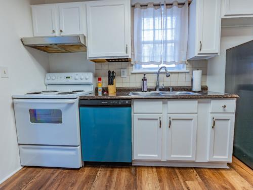 a kitchen with white cabinets and blue appliances at Columbus air pad in Columbus