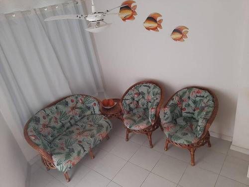 two chairs in a room with butterflies on them at Sobrado confortável a uma quadra do mar. in Matinhos