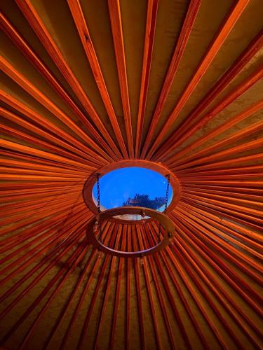 a ceiling of a tent with a window in it at Glamping montain experience in São Joaquim
