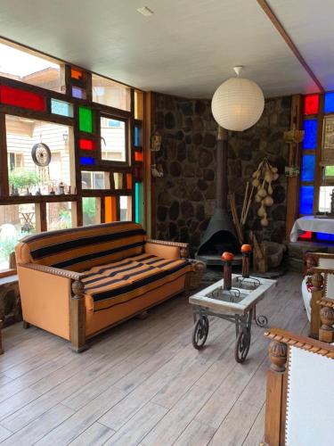 a living room with a bed and a fireplace at Hotel Faro del Valle in Pisco Elqui