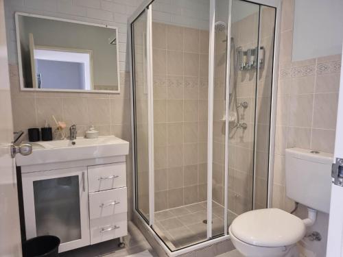 a bathroom with a shower and a toilet and a sink at Tuggeranong Short Stay #07C - Sleeps 6 in Canberra