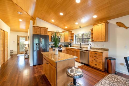 a kitchen with wooden cabinets and stainless steel appliances at Camp Manatee – Majestic Estate on Santa Fe River in Fort White