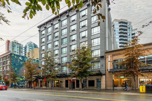 a tall building on a city street with buildings at Quality Inn & Suites in Vancouver