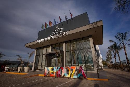 a building with a sign in front of it at Fuente Mayor Hotel Terminal in Mendoza