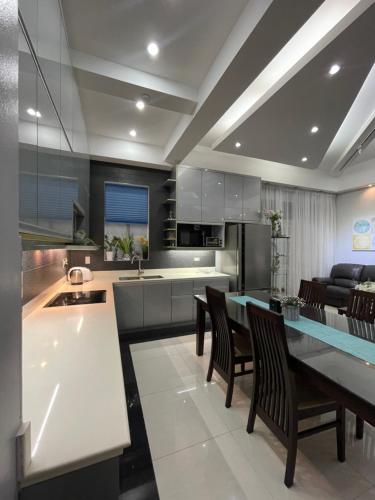 a kitchen with a table and chairs in a kitchen at Anavada Apartment - Davao City in Davao City