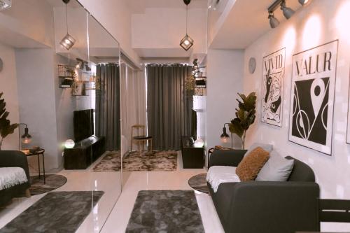 a living room with a couch and a table at Uptown Parksuites 1BR with Wi-Fi, Free Netflix, Washer & Pool View in Manila