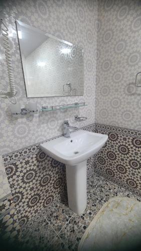 a bathroom with a sink and a mirror at Dari Zanjir in Samarkand