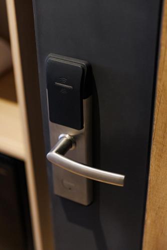 a close up of a door with a metal handle at Fuente Mayor Hotel Terminal in Mendoza